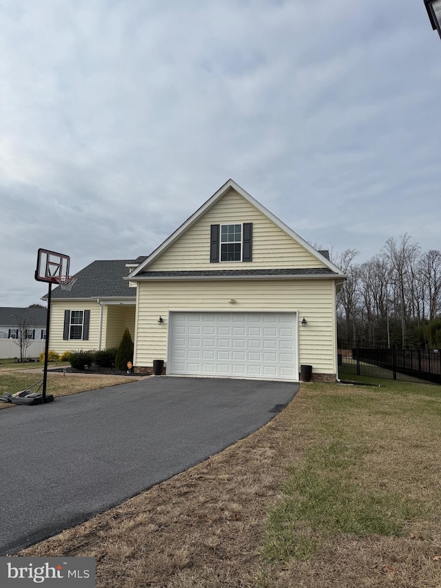 view of front of home with a front yard and a garage