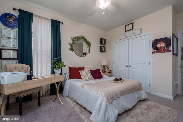 carpeted bedroom with ceiling fan and a closet