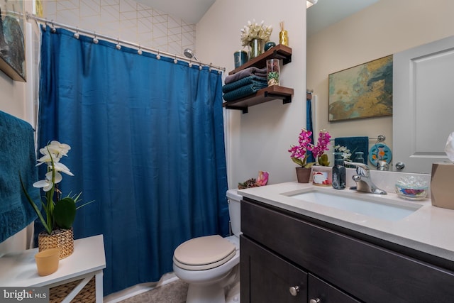 bathroom with tile patterned floors, vanity, and toilet