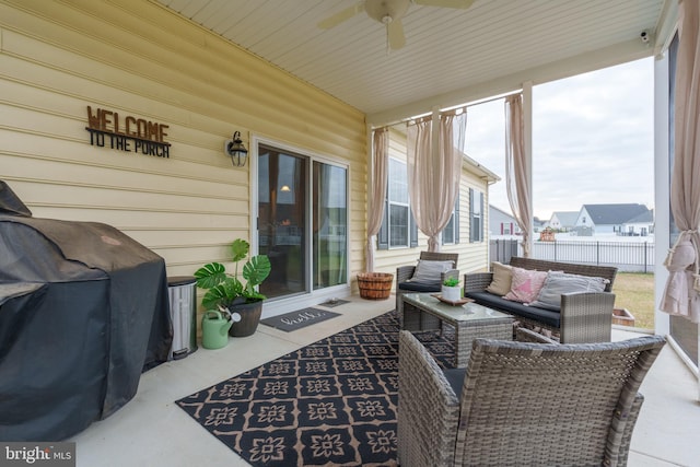 sunroom with ceiling fan and wooden ceiling