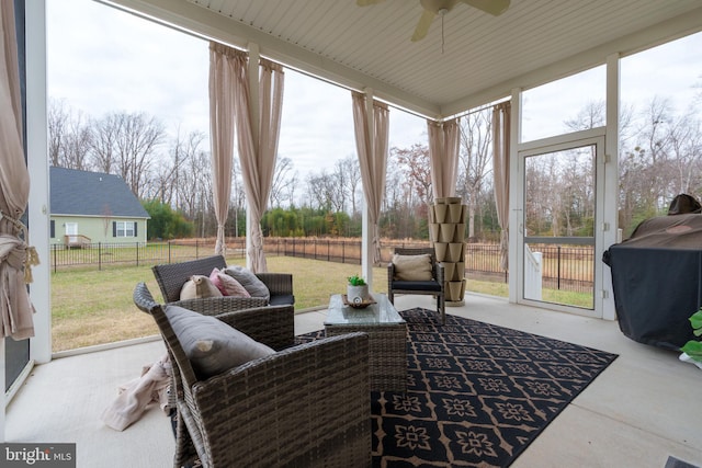 sunroom featuring ceiling fan and a healthy amount of sunlight