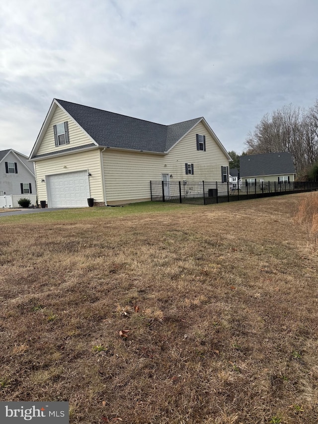 view of home's exterior featuring a lawn and a garage