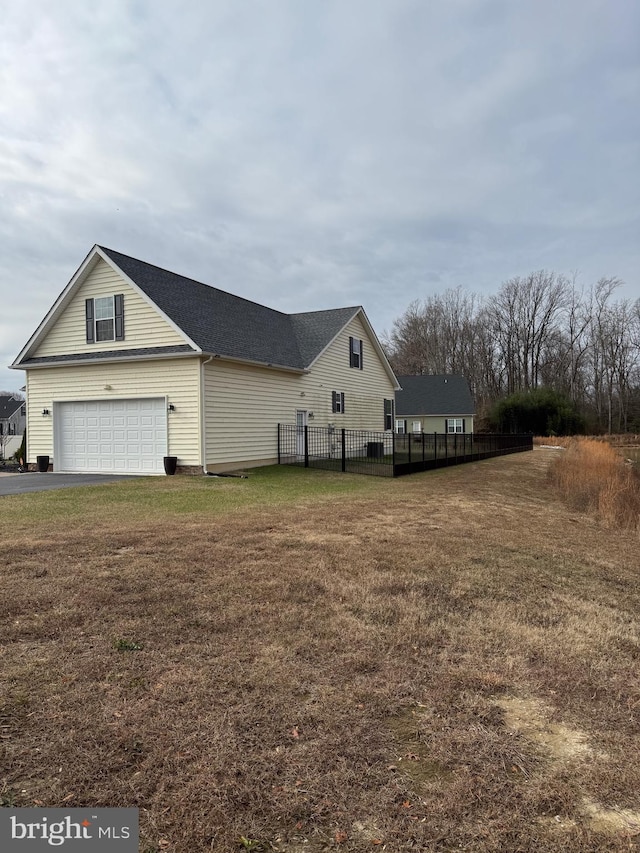 view of property exterior featuring a lawn and a garage