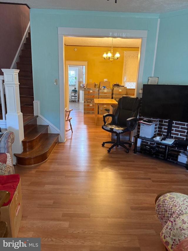 office area with hardwood / wood-style floors, a textured ceiling, and an inviting chandelier