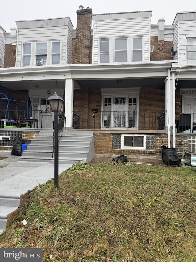 view of front of house featuring a front yard and a trampoline