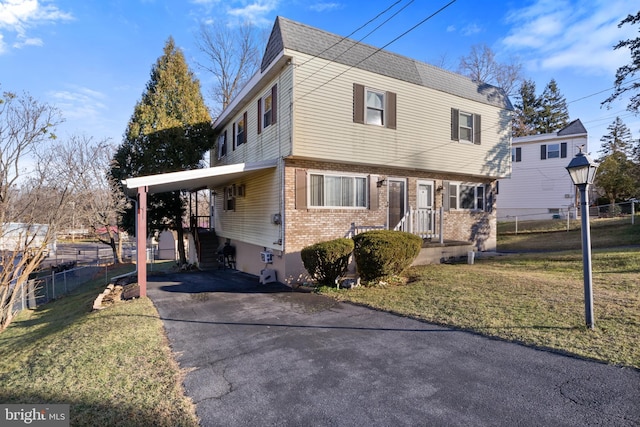 view of front property with a front yard and a carport