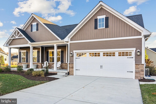 craftsman-style house featuring a porch and a garage