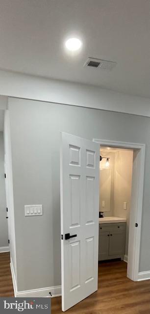 corridor featuring hardwood / wood-style flooring