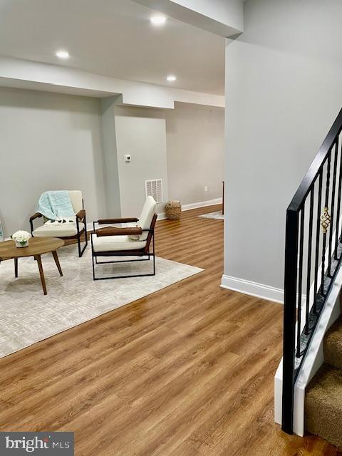 living area with hardwood / wood-style flooring