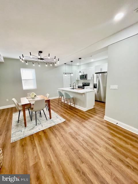 unfurnished dining area with light hardwood / wood-style flooring and sink