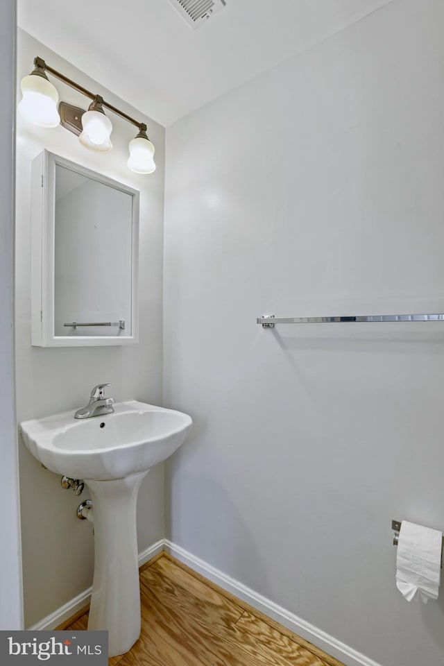 bathroom with hardwood / wood-style flooring