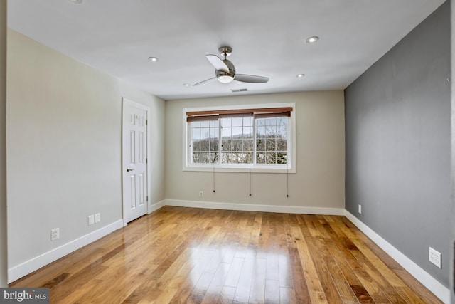 unfurnished room with ceiling fan and light wood-type flooring