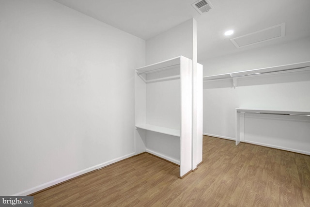 spacious closet featuring light hardwood / wood-style floors