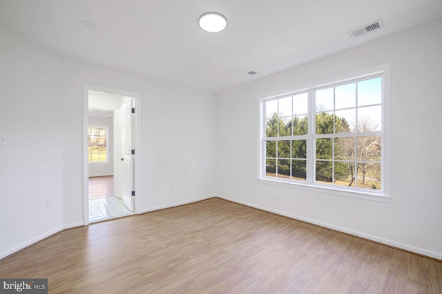 empty room with light hardwood / wood-style floors