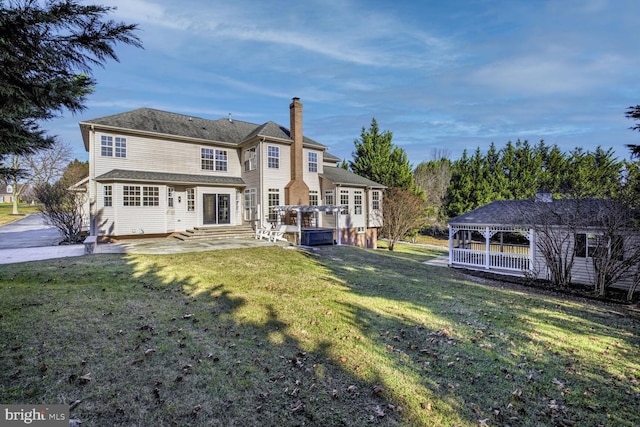 rear view of house featuring a yard