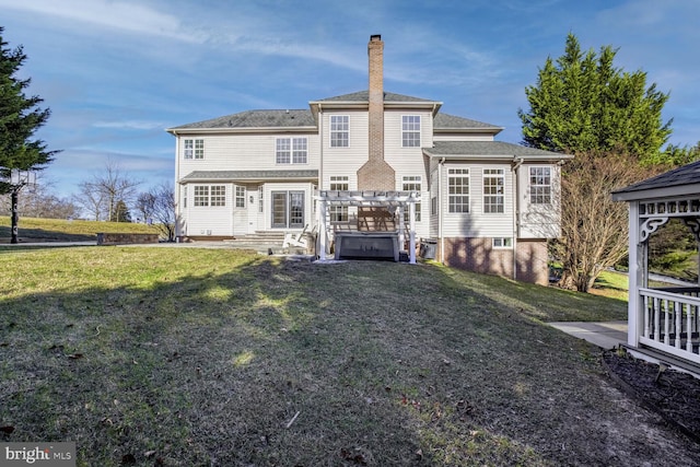 rear view of property featuring a lawn and a pergola