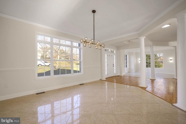 unfurnished dining area with light wood-type flooring, crown molding, a wealth of natural light, and an inviting chandelier