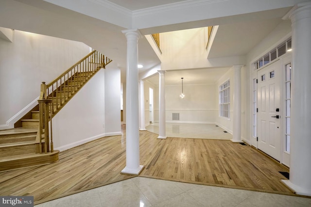 foyer featuring crown molding and light hardwood / wood-style floors