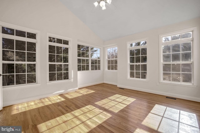 unfurnished sunroom featuring vaulted ceiling