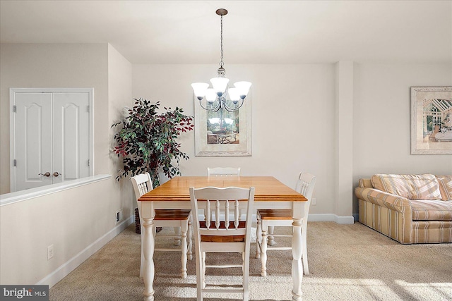 dining room with light colored carpet and a notable chandelier