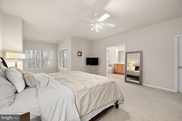 bedroom with light carpet, connected bathroom, and ceiling fan