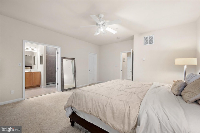 carpeted bedroom featuring ensuite bath and ceiling fan