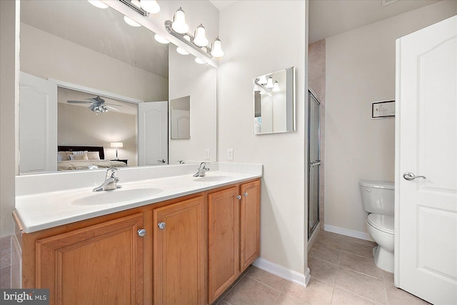 bathroom with ceiling fan, tile patterned flooring, an enclosed shower, toilet, and vanity