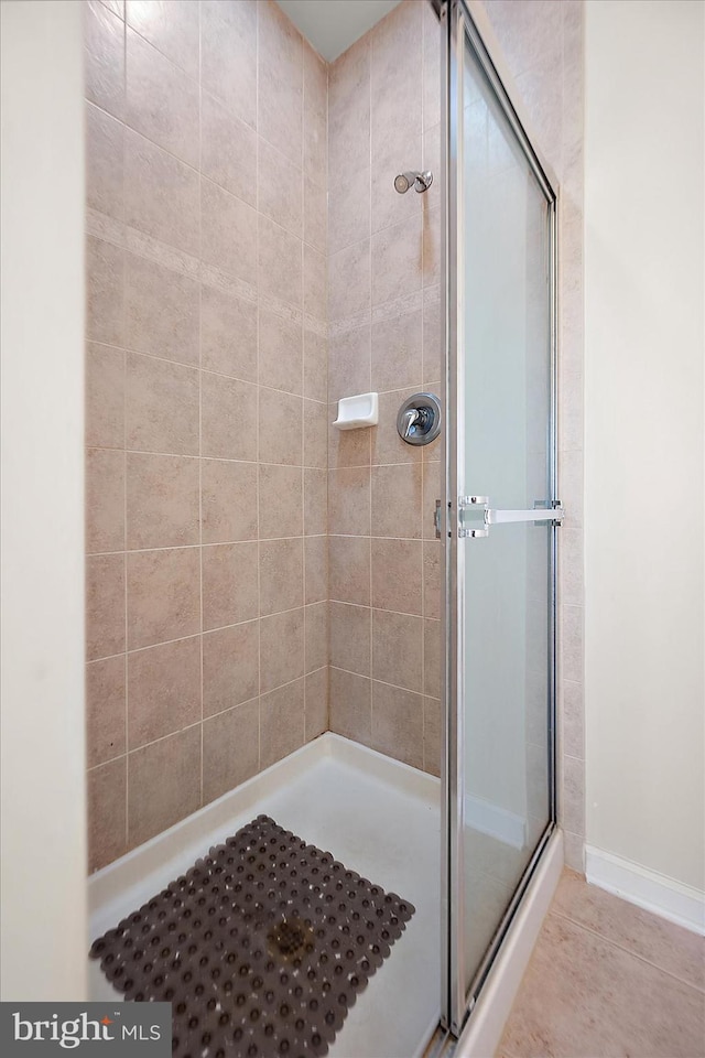 bathroom with tile patterned flooring and an enclosed shower