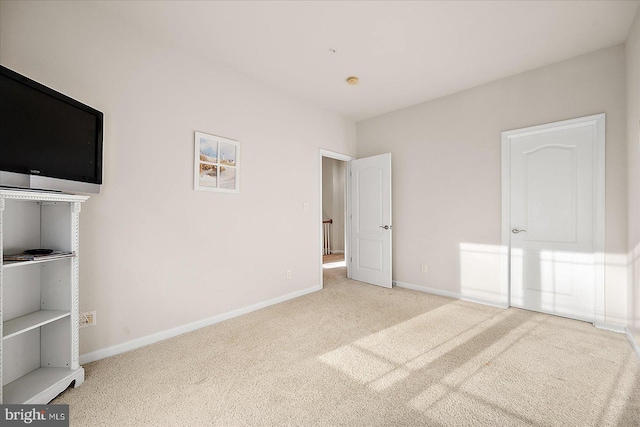 unfurnished bedroom with light colored carpet