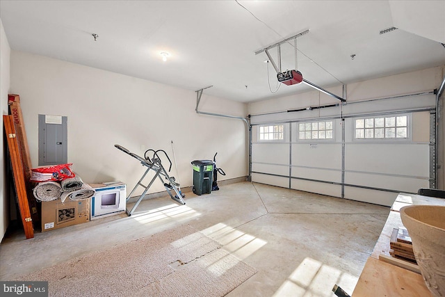 garage featuring electric panel and a garage door opener