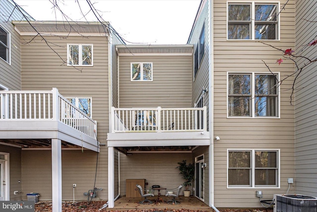 rear view of property with central AC, a patio area, and a balcony