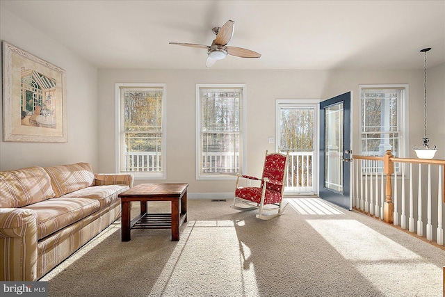 carpeted living room featuring ceiling fan