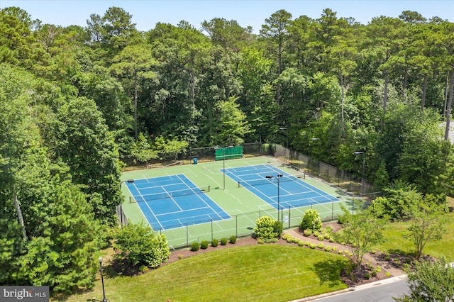 view of tennis court with a yard