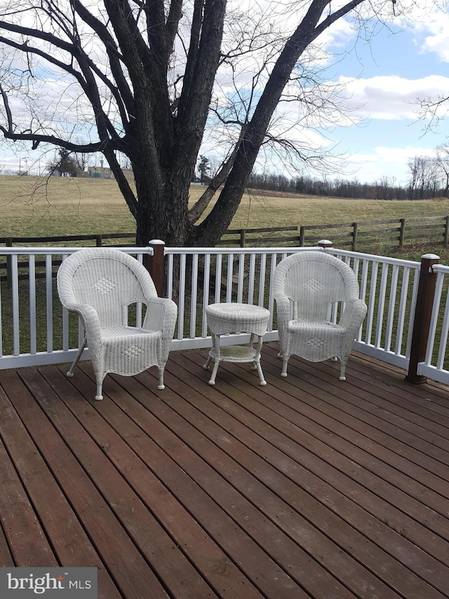 wooden terrace featuring a rural view