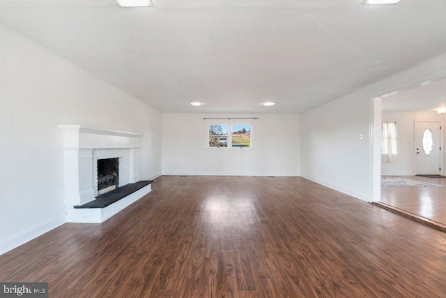 unfurnished living room with dark hardwood / wood-style floors and a fireplace