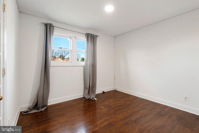 empty room with dark hardwood / wood-style floors