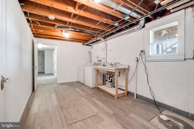 basement featuring wood-type flooring and independent washer and dryer