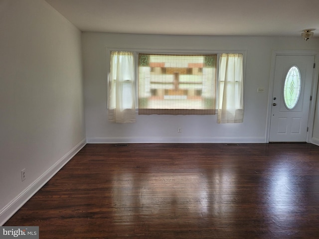 entryway with dark hardwood / wood-style flooring