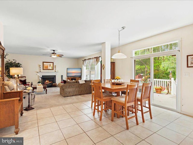 dining area featuring ceiling fan, light tile patterned floors, and a healthy amount of sunlight