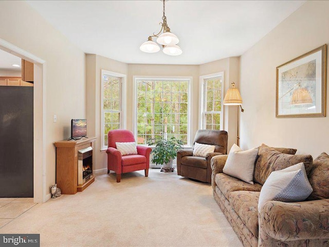 living room featuring light carpet, plenty of natural light, and an inviting chandelier