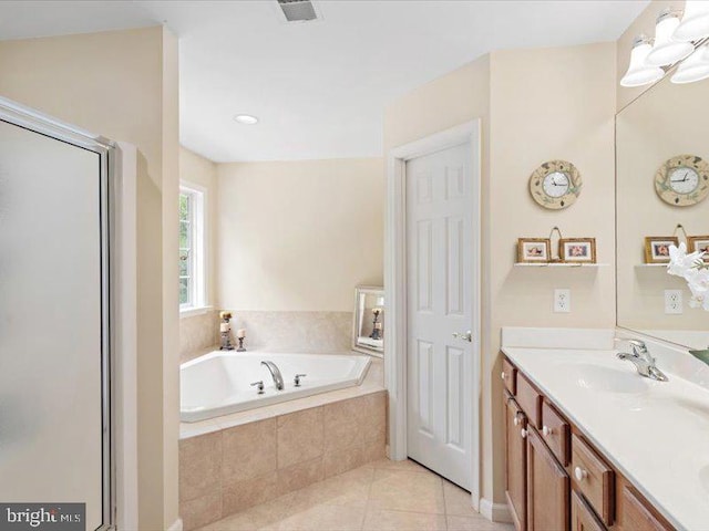 bathroom with tile patterned flooring, vanity, and plus walk in shower