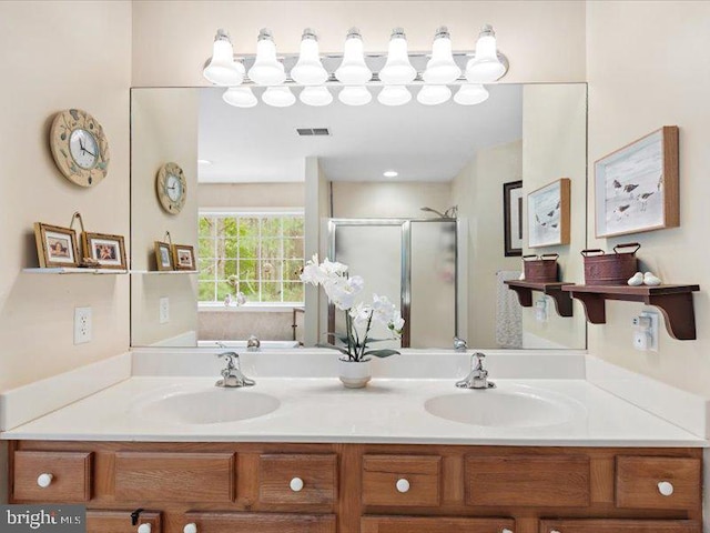 bathroom with vanity and a shower with shower door