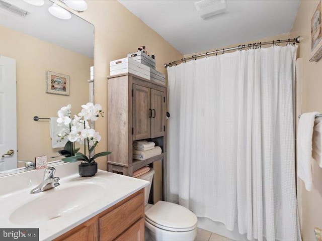 bathroom with tile patterned floors, vanity, and toilet