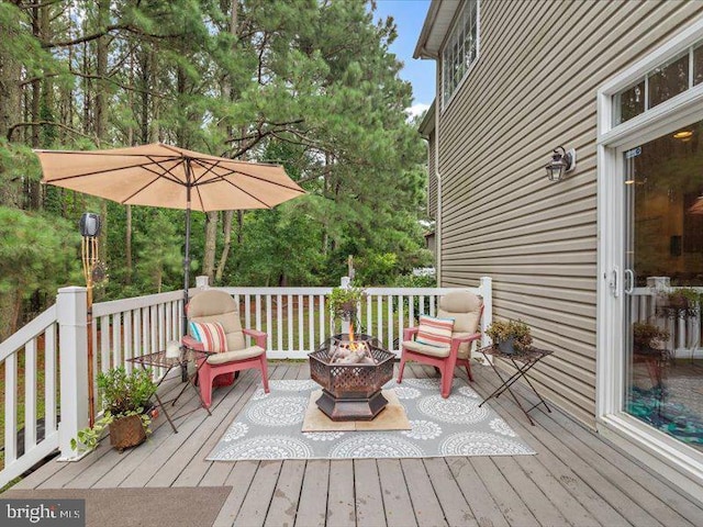 wooden terrace with a fire pit