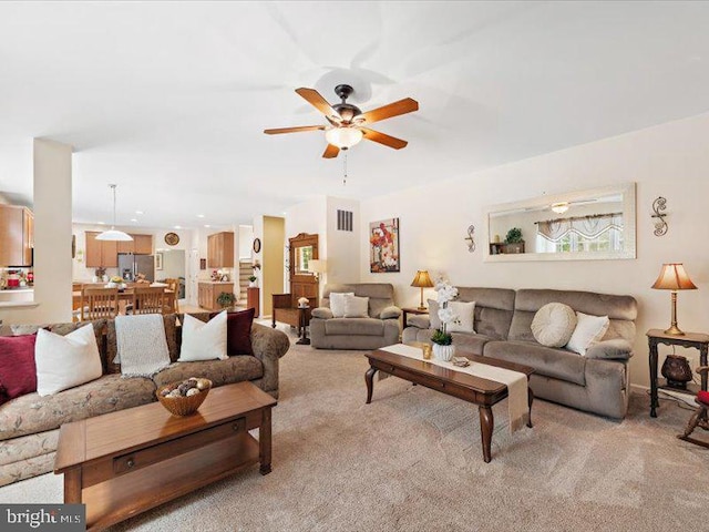 living room featuring ceiling fan and light carpet