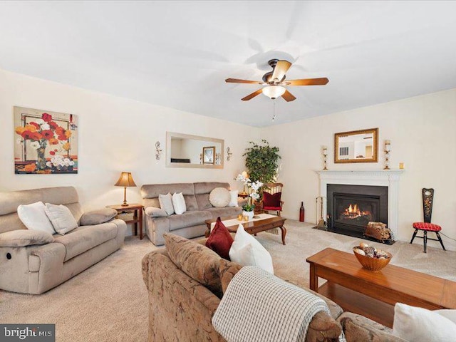 carpeted living room with ceiling fan