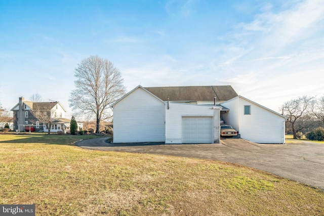 view of side of property with a garage and a yard