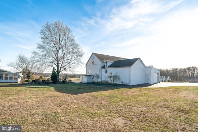 view of property exterior featuring a lawn and a garage