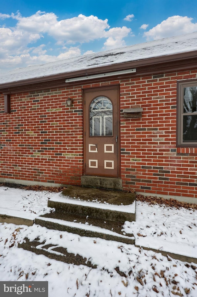 view of snow covered property entrance