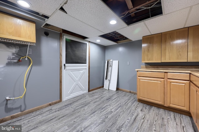 kitchen featuring light hardwood / wood-style flooring and a paneled ceiling